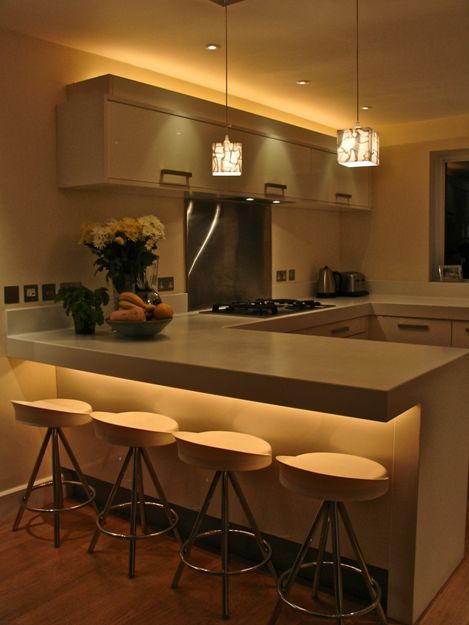 Contemporary kitchen with under-counter and above-cabinet lighting.