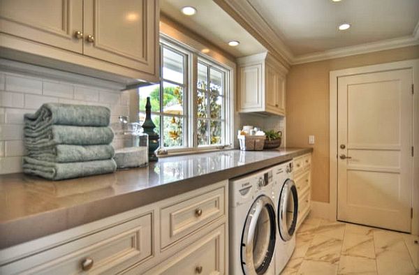 One wall laundry room with side-by-side washer and dryer. Recreate this space with our Signature Pearl kitchen cabinets. | Photo Source: decoist.com